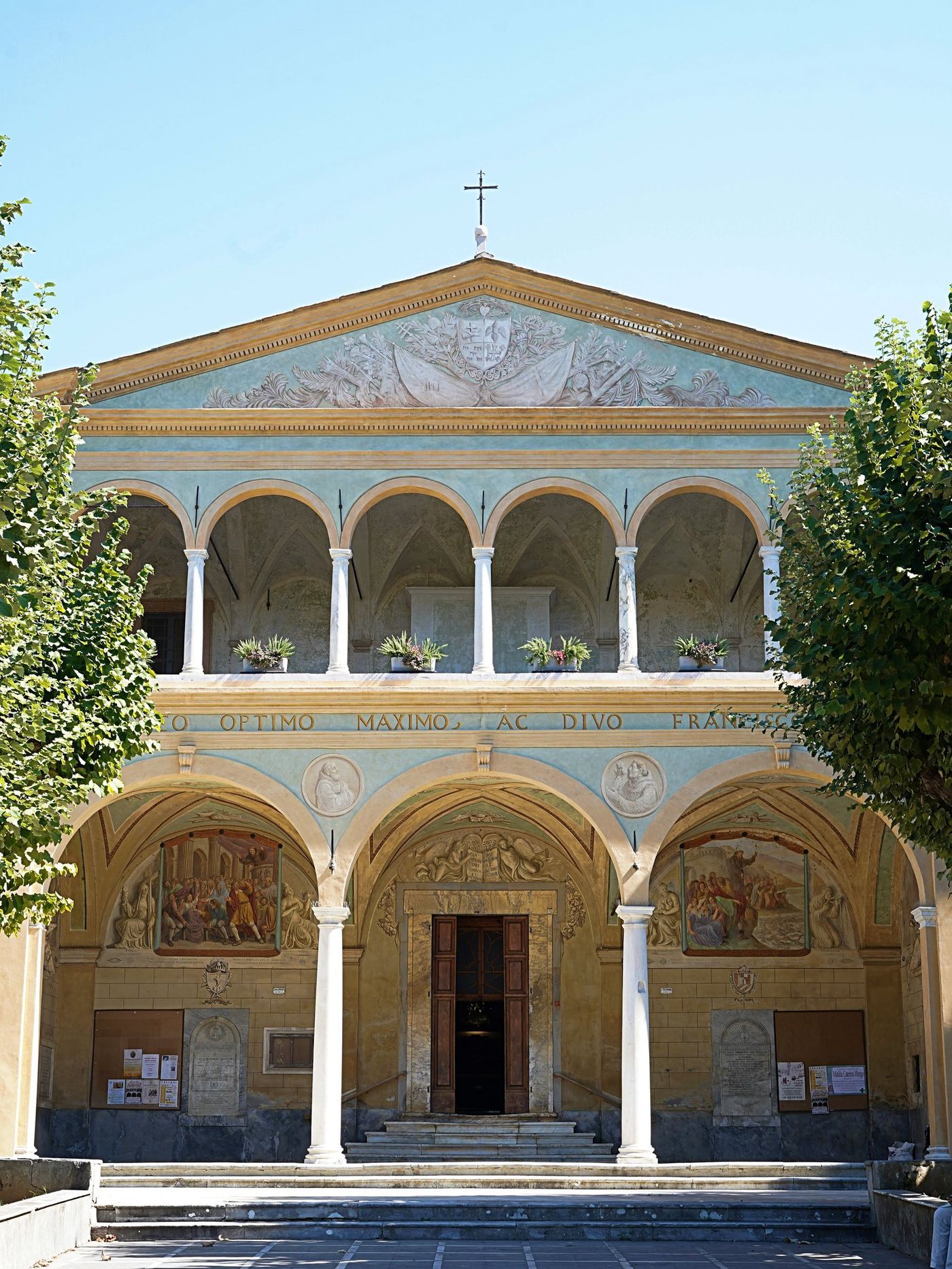 The painted façade and two-tier loggia of the church on the square in Pietrasanta