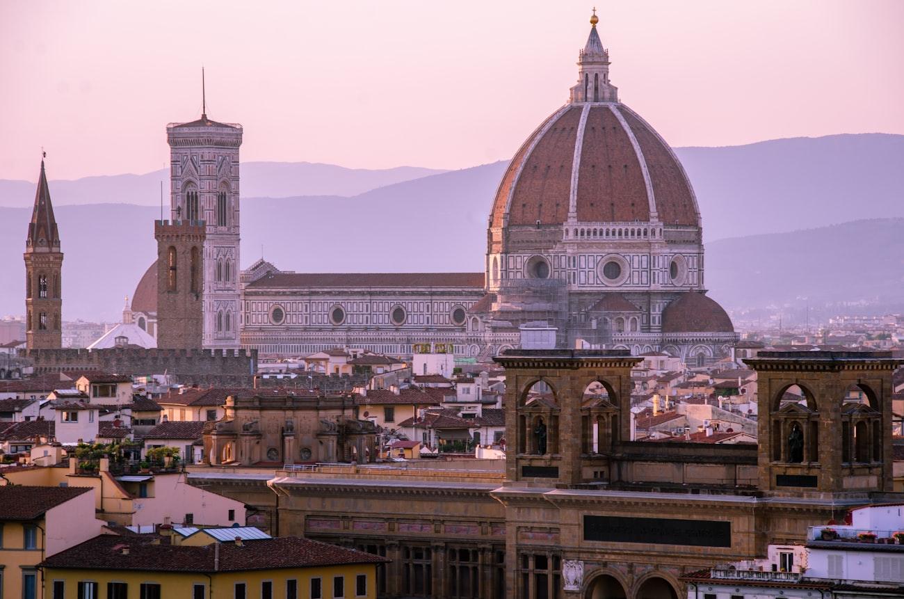 The dome and bell tower of Florence rising over terracotta roofs