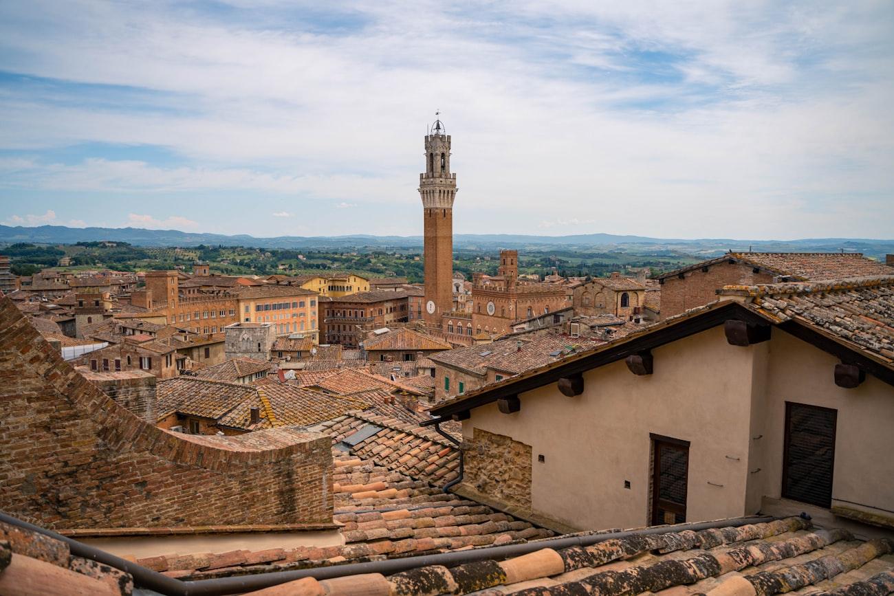 Rooftops and a bell tower in a walled Tuscan town